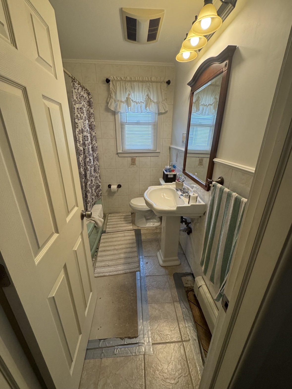 Narrow bathroom with new vanity