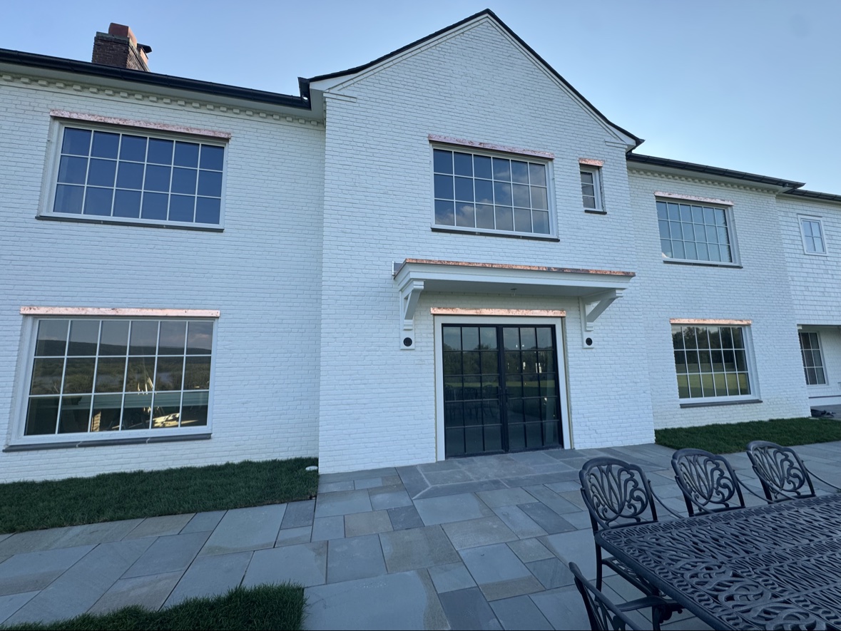 White brick home with patio