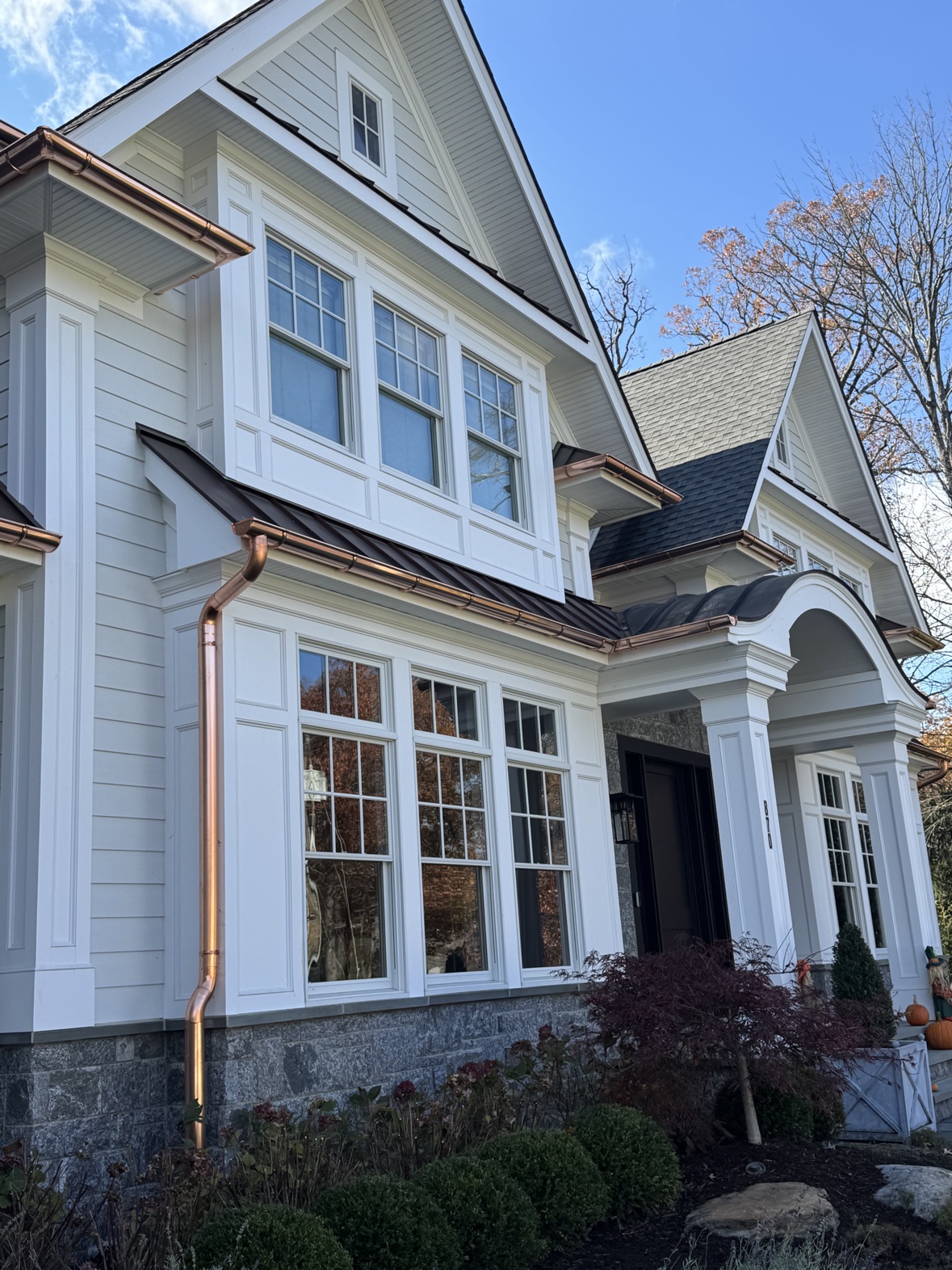 White home with new copper gutters and windows